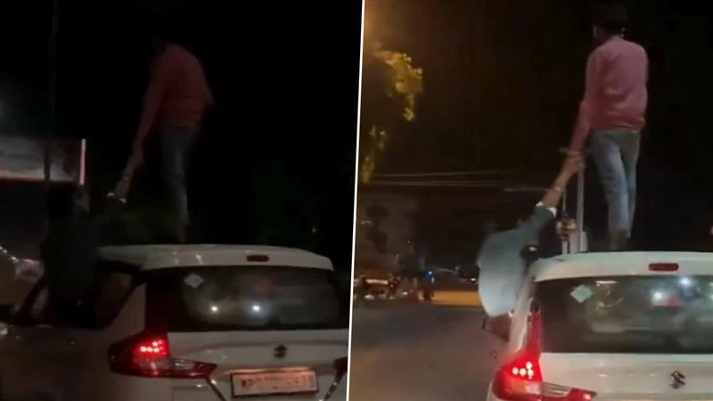 Madhya Pradesh Viral Video: ব্যস্ত রাস্তায় চলন্ত গাড়ির ছাদে দাঁড়িয়ে যুবকের কায়দাবাজি, ভয়ডরের লেশমাত্র নেই, দেখুন ভাইরাল ভিডিয়ো
